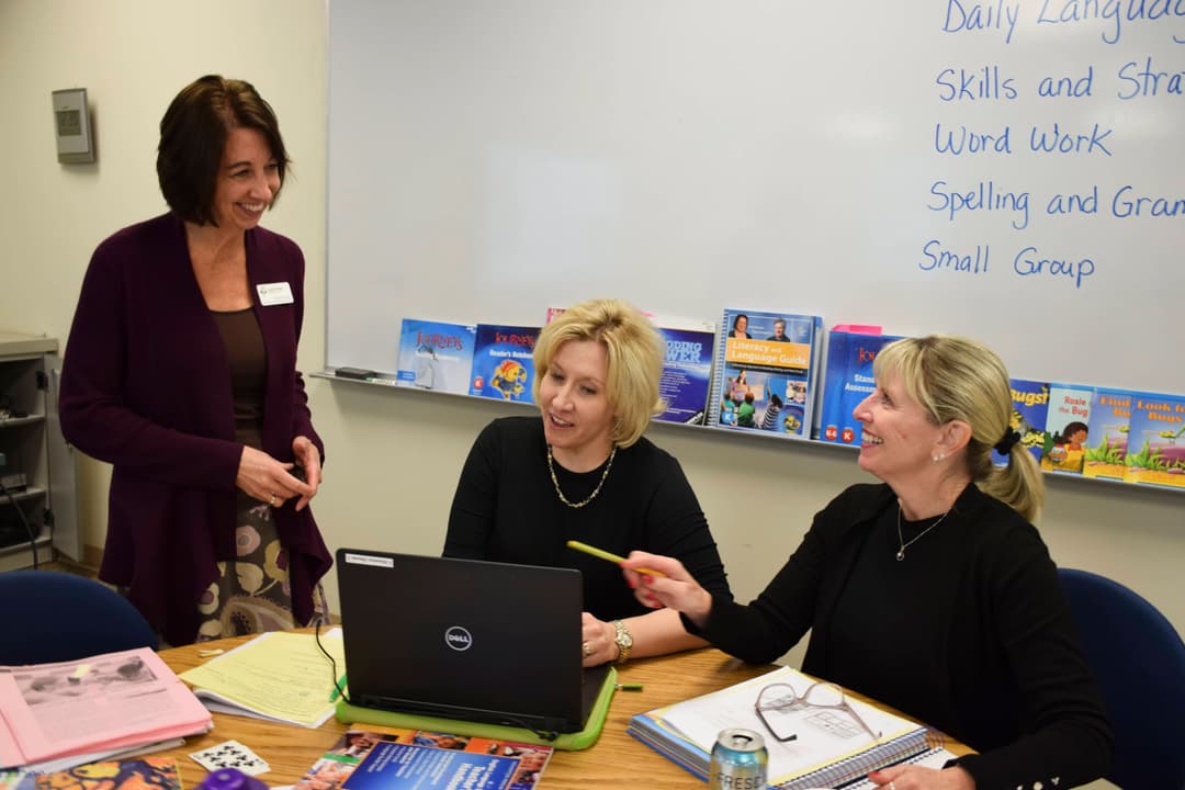 Cristianne in a meeting with fellow teachers